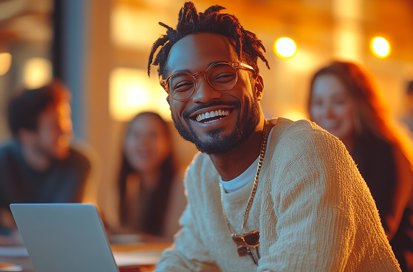 A man laughing with office workers in bright space”