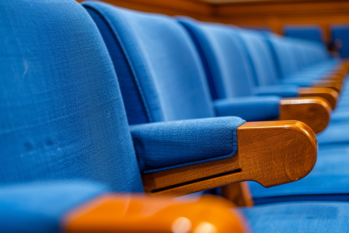 Clean blue seats in orderly auditorium under soft light