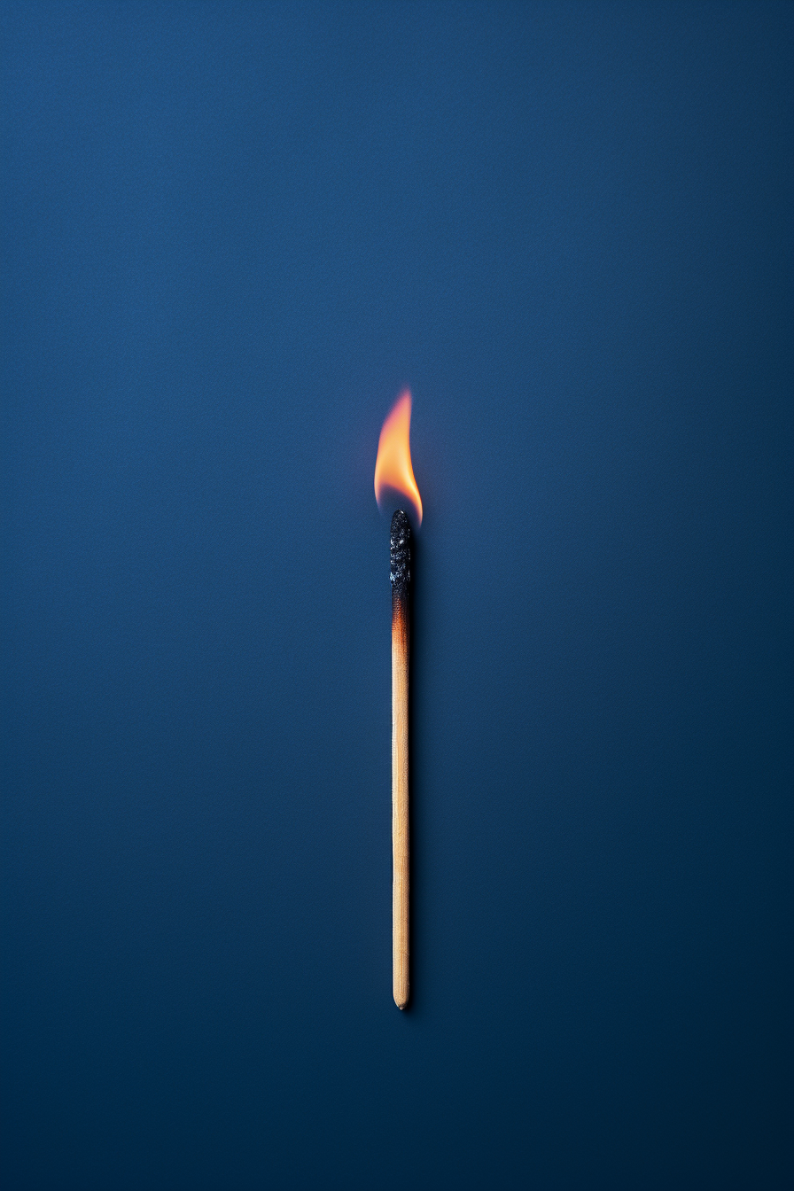 burned match on dark blue background