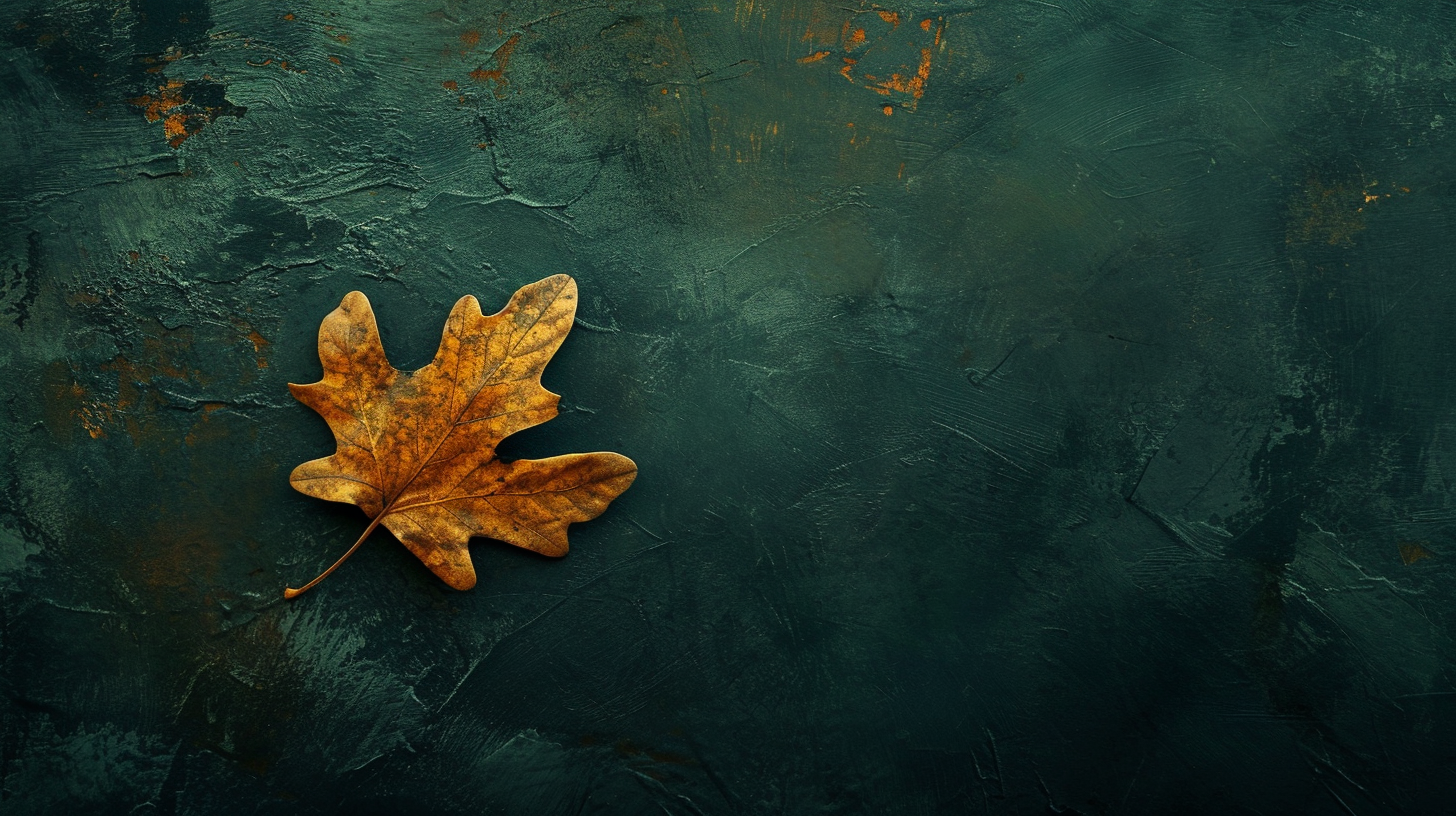 Golden oak leaf falling on dark green background