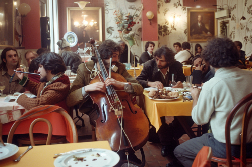 70s musicians enjoying meal together