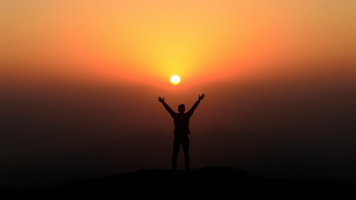 A Person Celebrating Sunrise Alone on Horizon