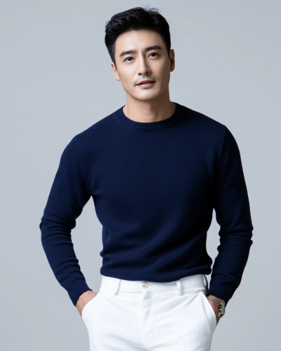 A man in casual outfit on blue backdrop