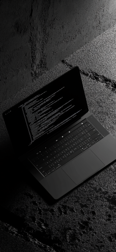 A stylish laptop showing code snippets on screen