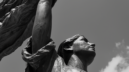 Bronze statue of woman holding United States on shoulders.