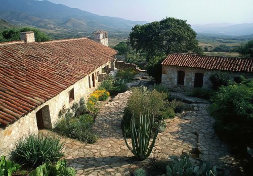 California Mission ranch, Frank Gehry design, courtyard, large windows.