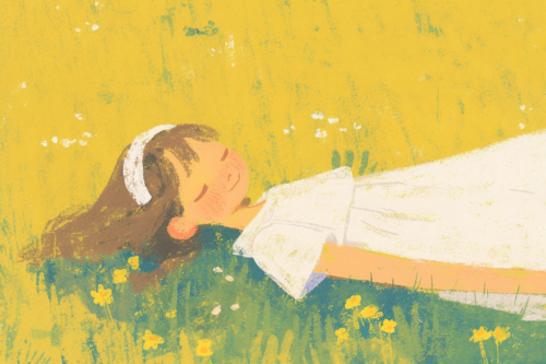 Cheerful girl in white dress on green grass