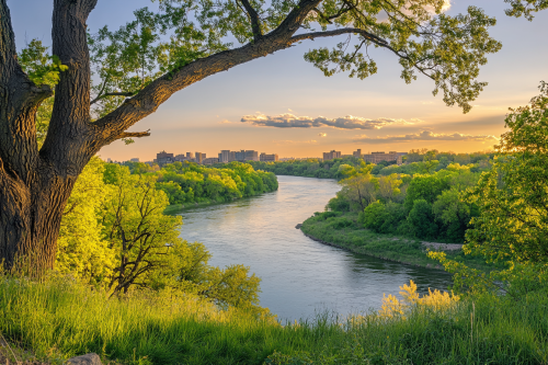 City skyline at sunset by river