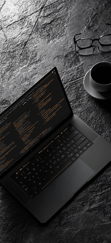 Dark laptop with code on screen, concrete background ambiance