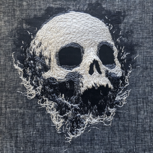 Embroidered ghostly skull dissolving into mist