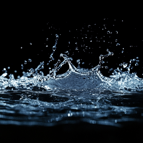 Realistic wall of water with splashes on black.
