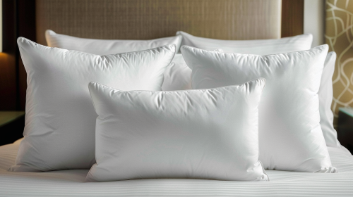 Soft white pillows on modern bed