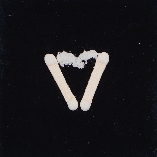 Two matchsticks in heart shape, flash photography, film.