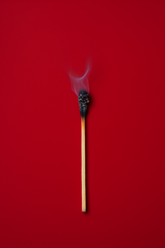 Matchstick on red background