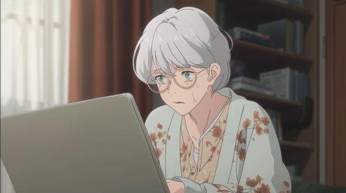 Elderly lady with white hair wearing glasses and cardigan