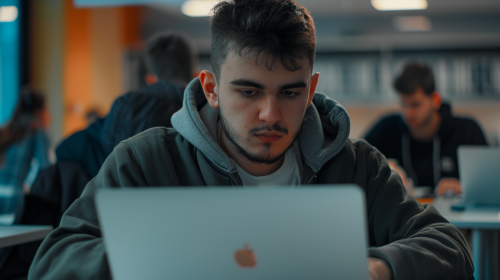 student using macbook in class student using macbook in class