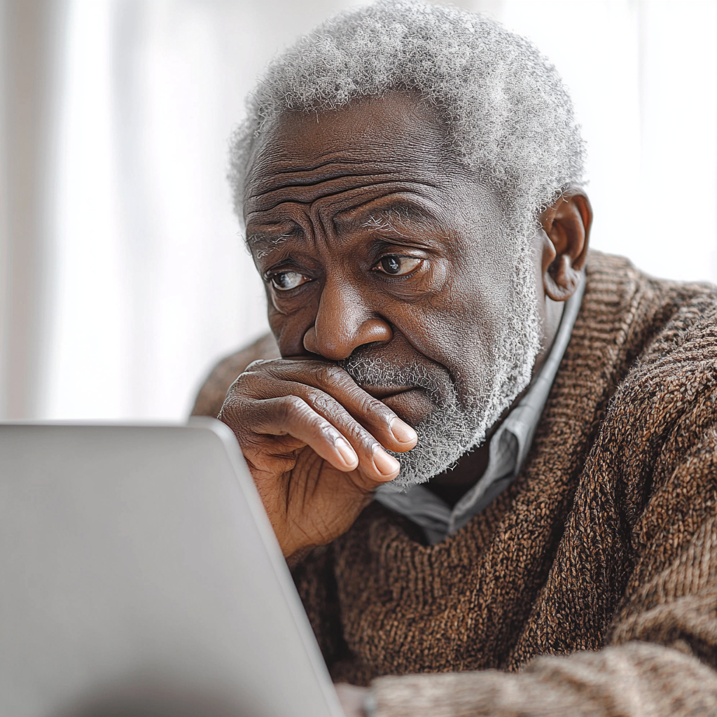 A Worried Old Man Looking at Laptop