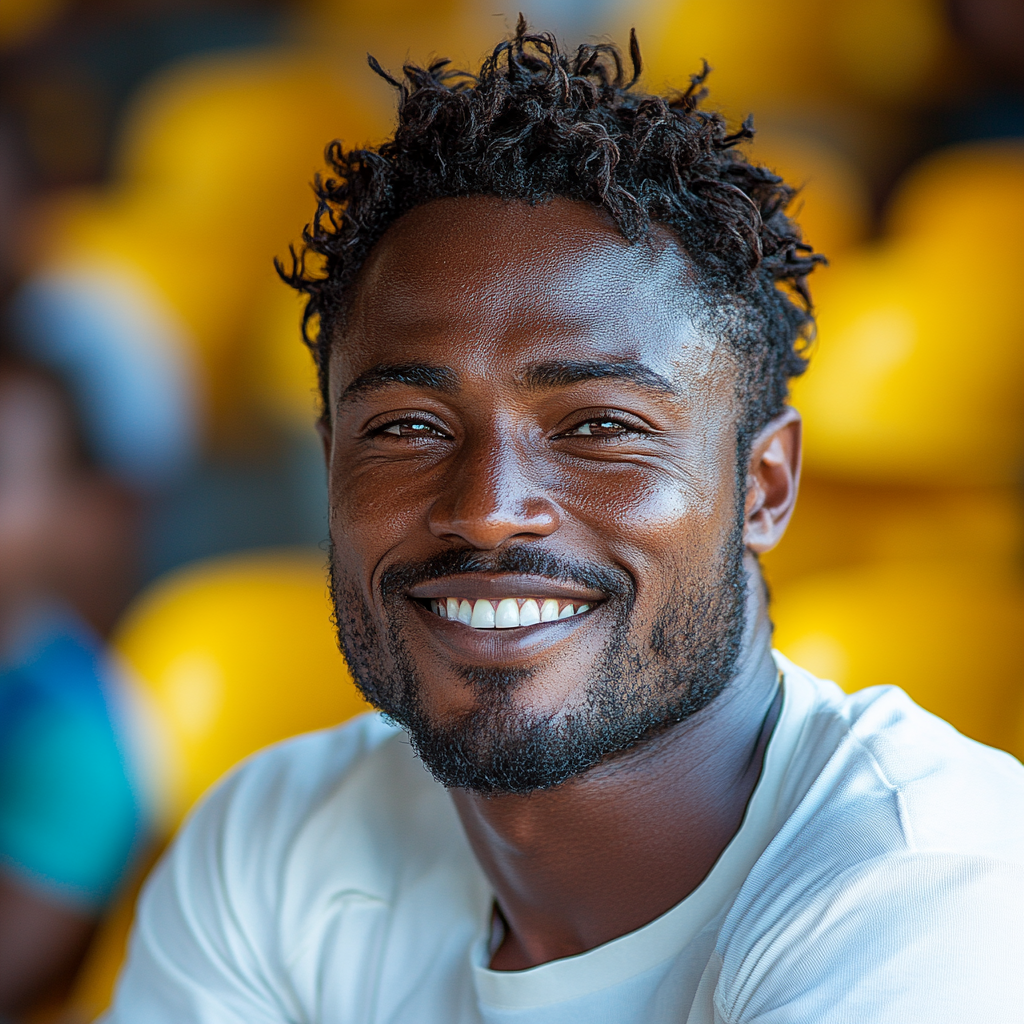 A happy Tanzanian man enjoying sports at stadium