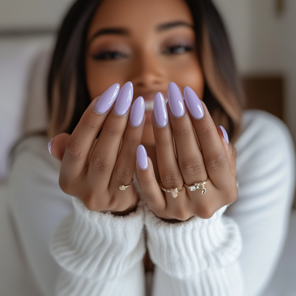 Candid photo of woman showing off new lavender nails.