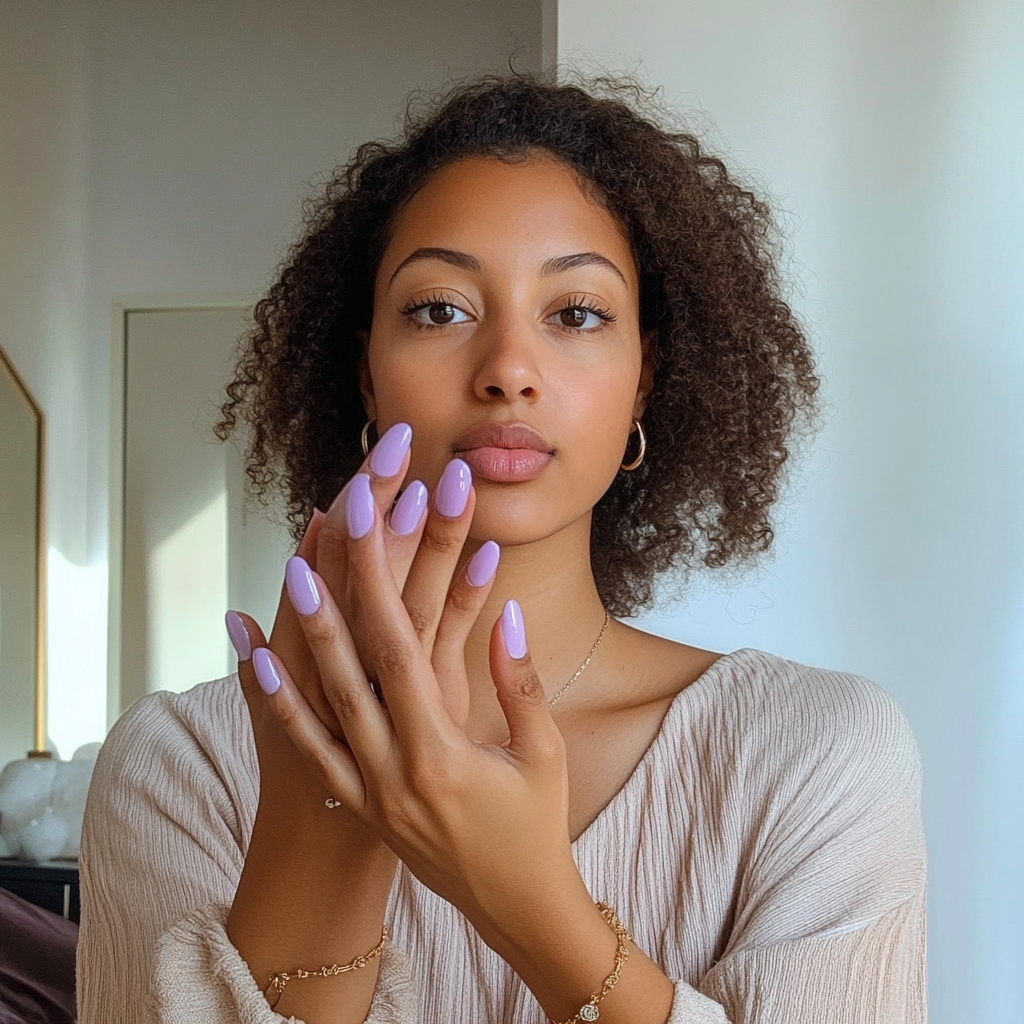 Candid photo of woman with new lilac nails.