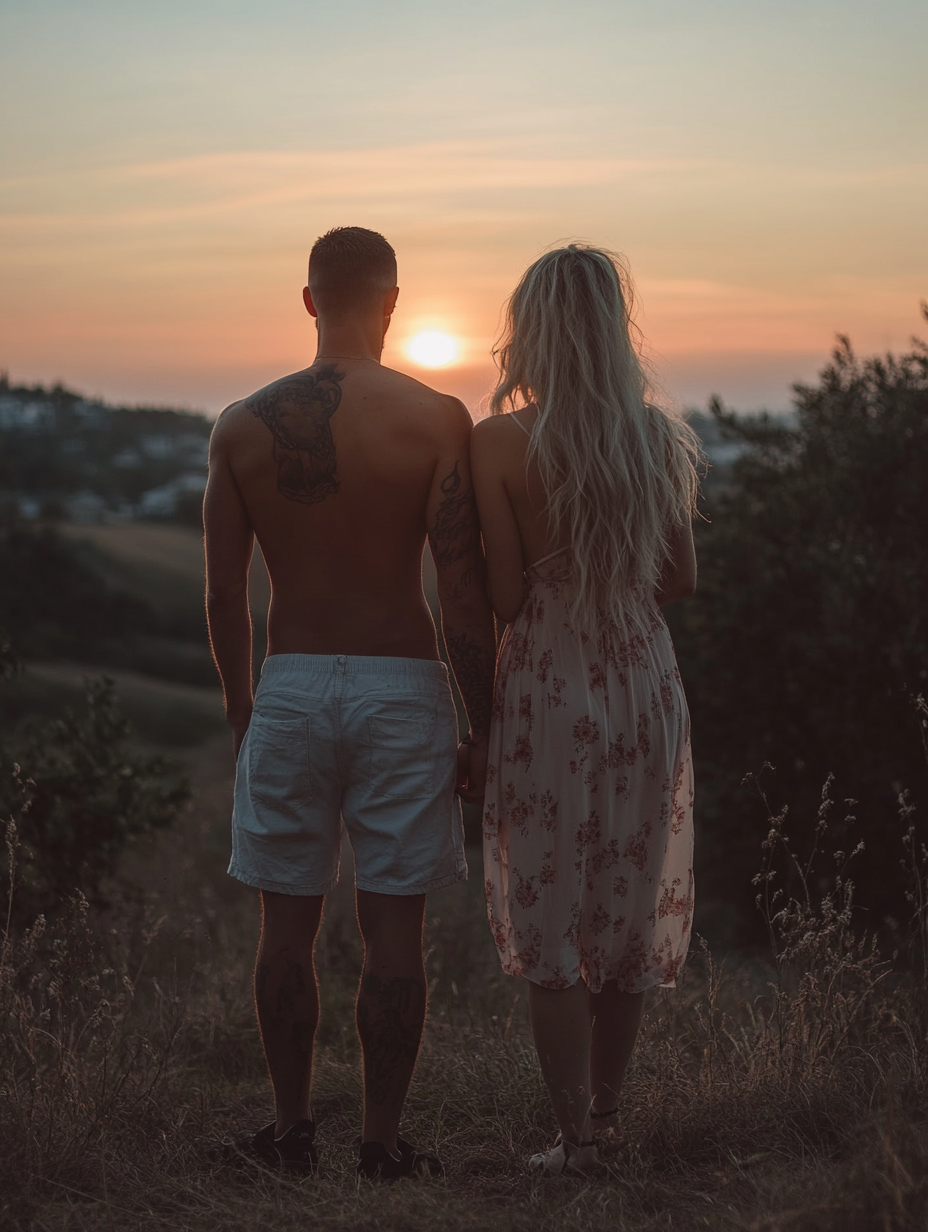 Couple at sunset, man with buzz cut, woman blonde.