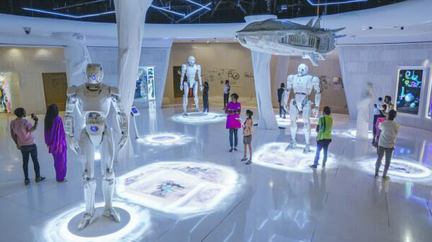 Large floor in modern science museum with Indian people.