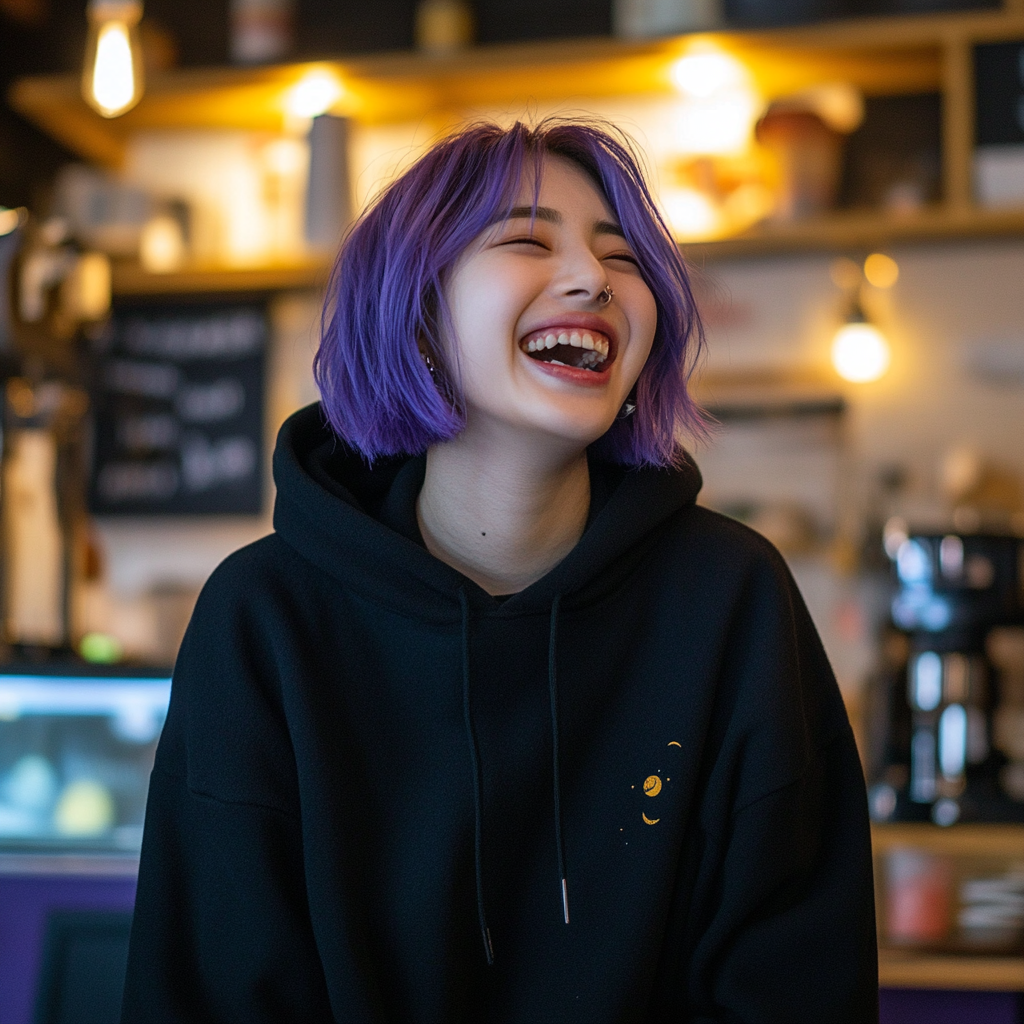 Laughing young Korean woman with purple bob, septum piercing.