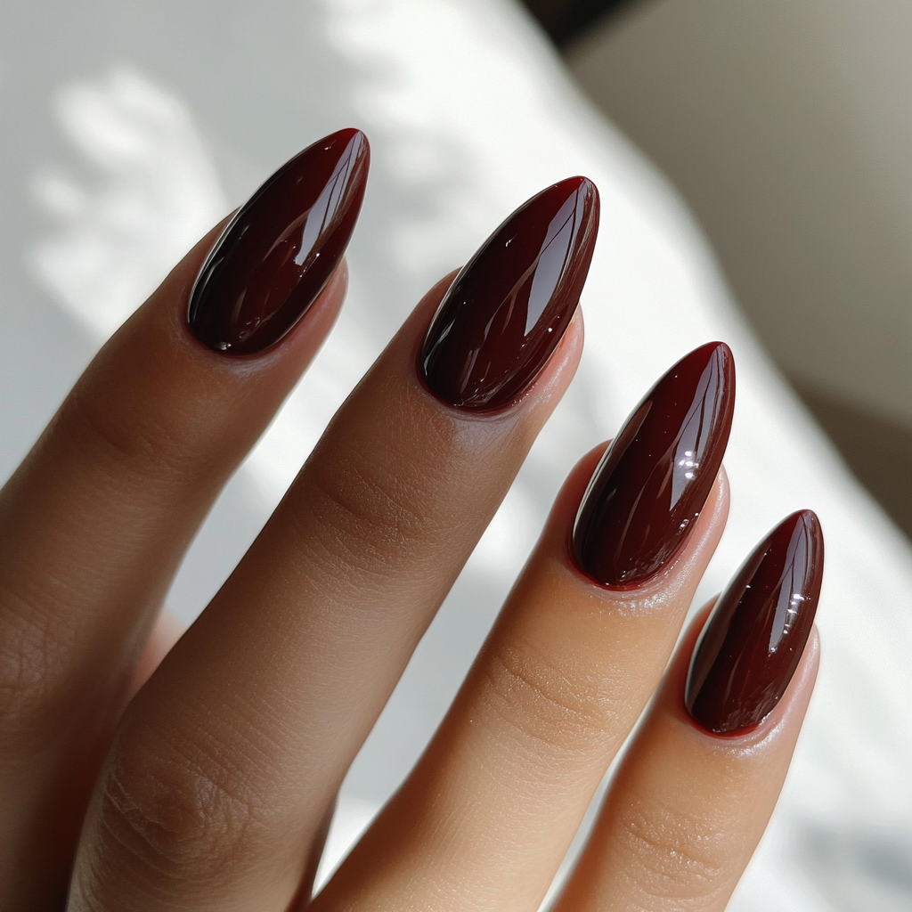 Photo of woman with new almond-shaped merlot nails.