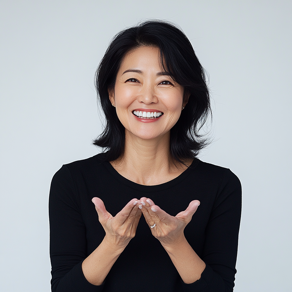 Trendy Korean woman in her 50s smiling confidently.