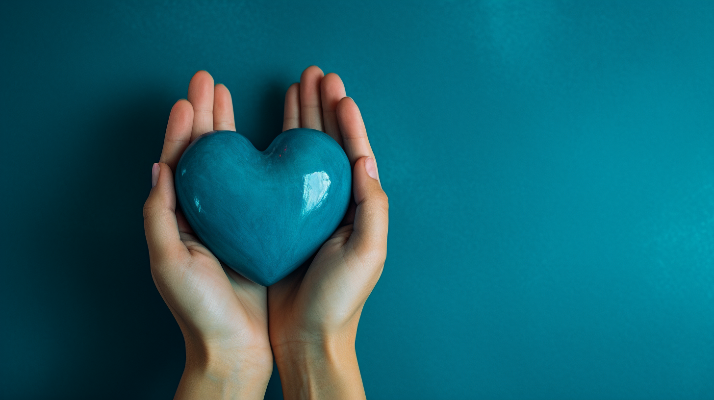 Hands holding heart on blue background