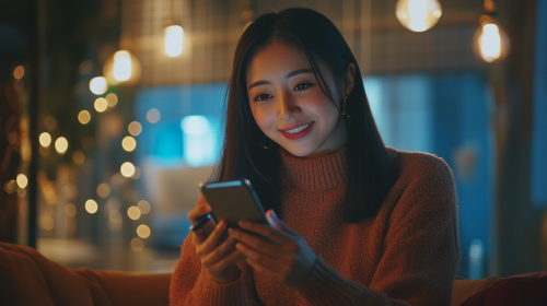 A Happy Asian Woman Managing Finances in Cafe