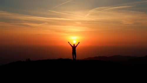 A Person Celebrating Sunrise Alone on Horizon