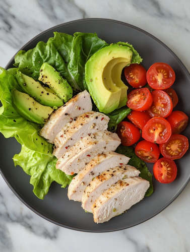 Delicious turkey plate on marble table with avocado.