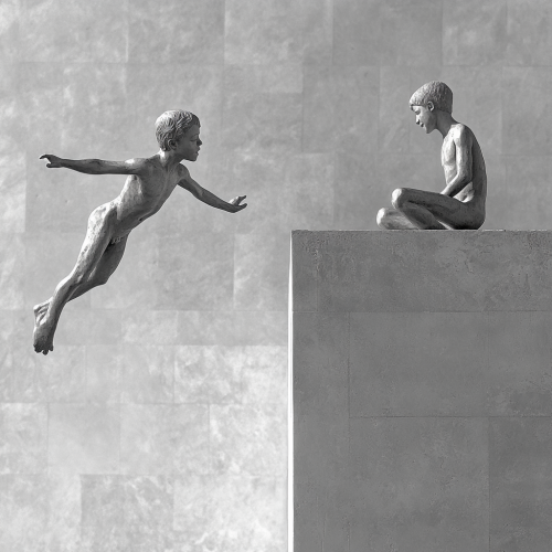 Elegant sculpture of two boys in dynamic pose.