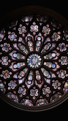 Intricate gothic stained glass rose window in dark pastels. Intricate gothic stained glass rose window in dark pastels.