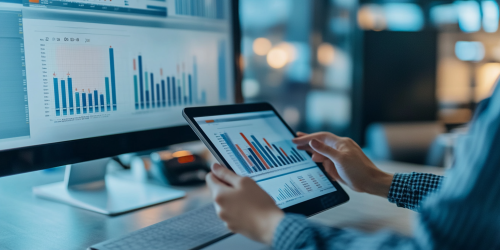 Person carefully tracking expenses on tablet in modern workspace. Person carefully tracking expenses on tablet in modern workspace.