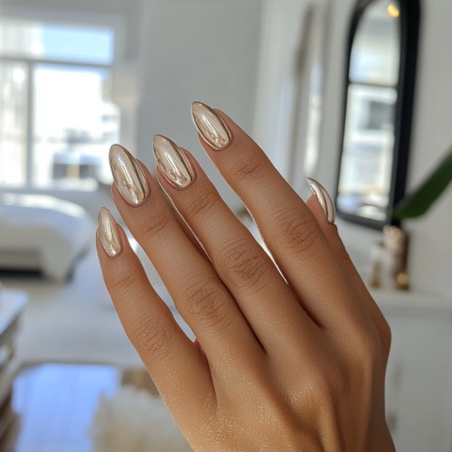 Photo of tan woman showing new champagne nails candidly.