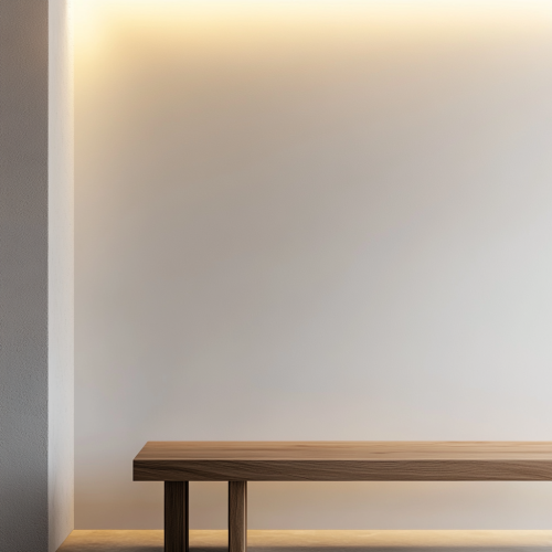 Smooth, clean white wall with blurred wooden bench edge.