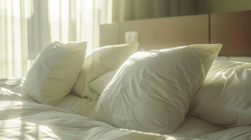 Soft white pillows on modern bed