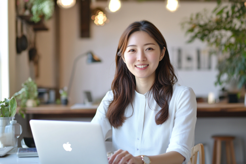 Sophisticated Japanese Woman Budgets on Laptop Brighly