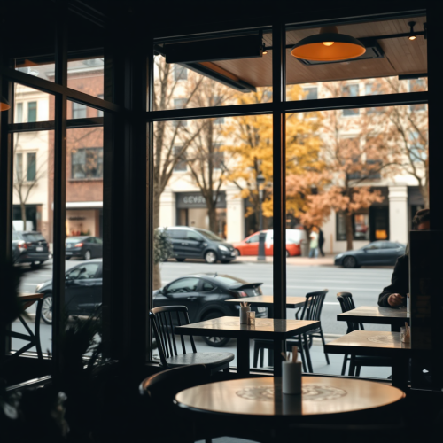 View of coffee shop through large window at night.