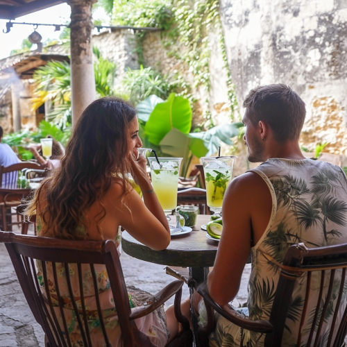 Couple drinking apple mojito tea in Cuban surrounding