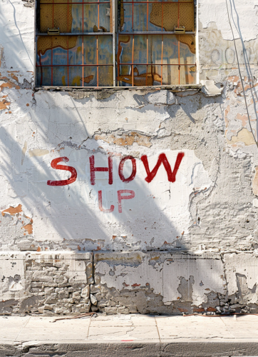 Distressed stucco wall red graffiti
