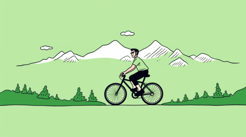 Young male on bicycle in mountain landscape