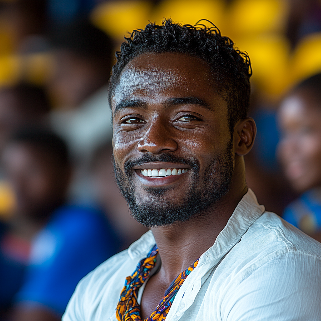 A happy Tanzanian man enjoying sports at stadium