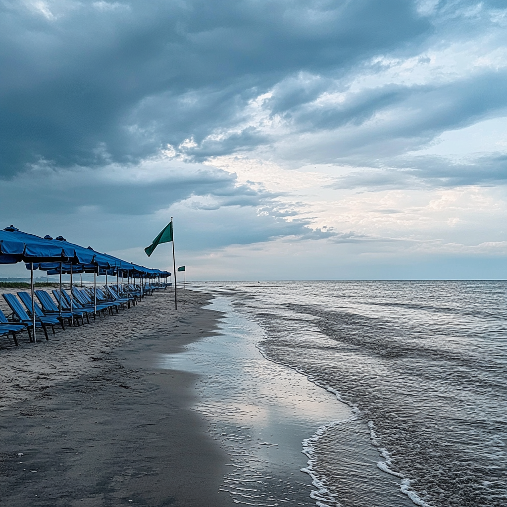 Beach scene in Long Island with umbrellas and chairs.