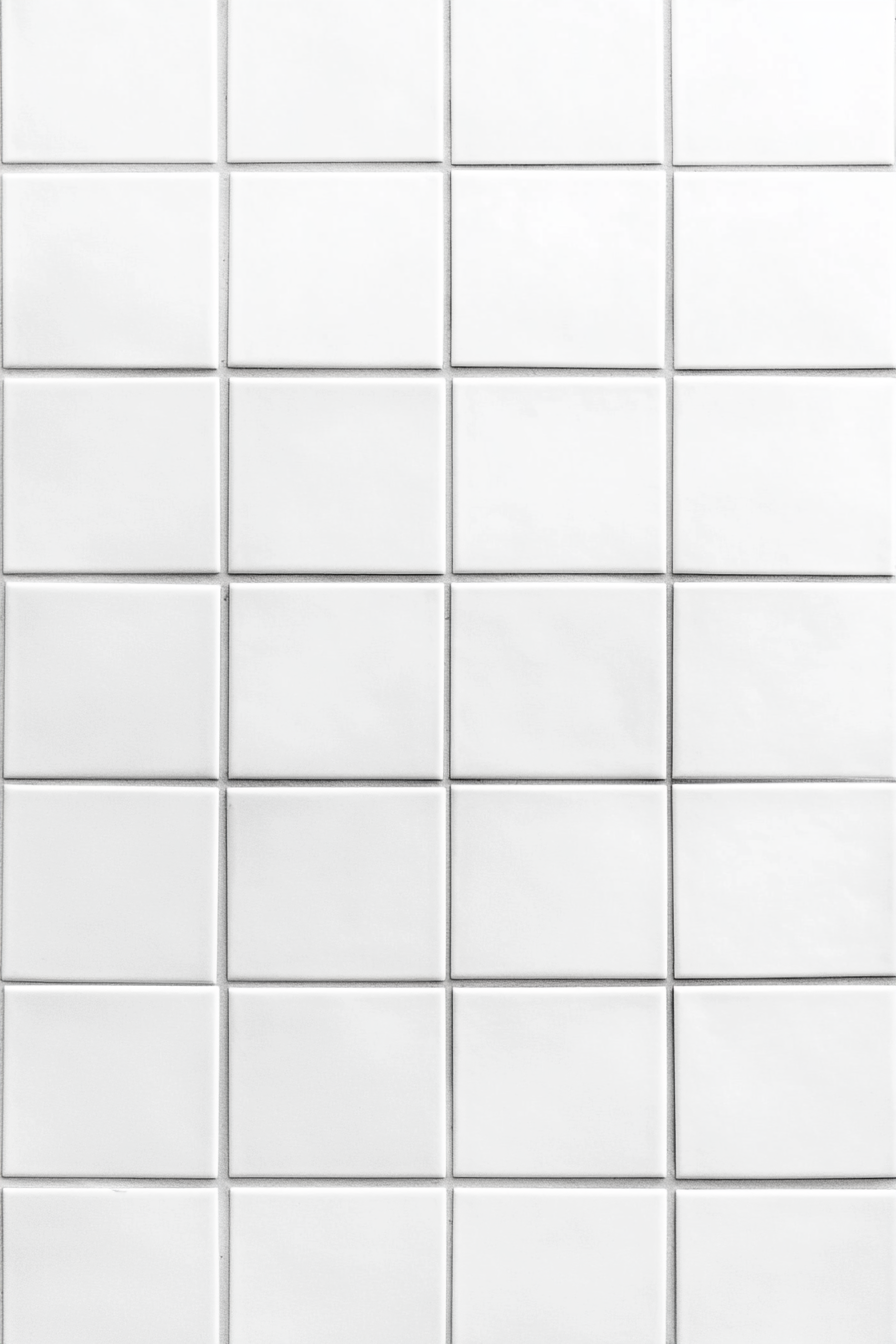 Bright white square tile wall background details focus