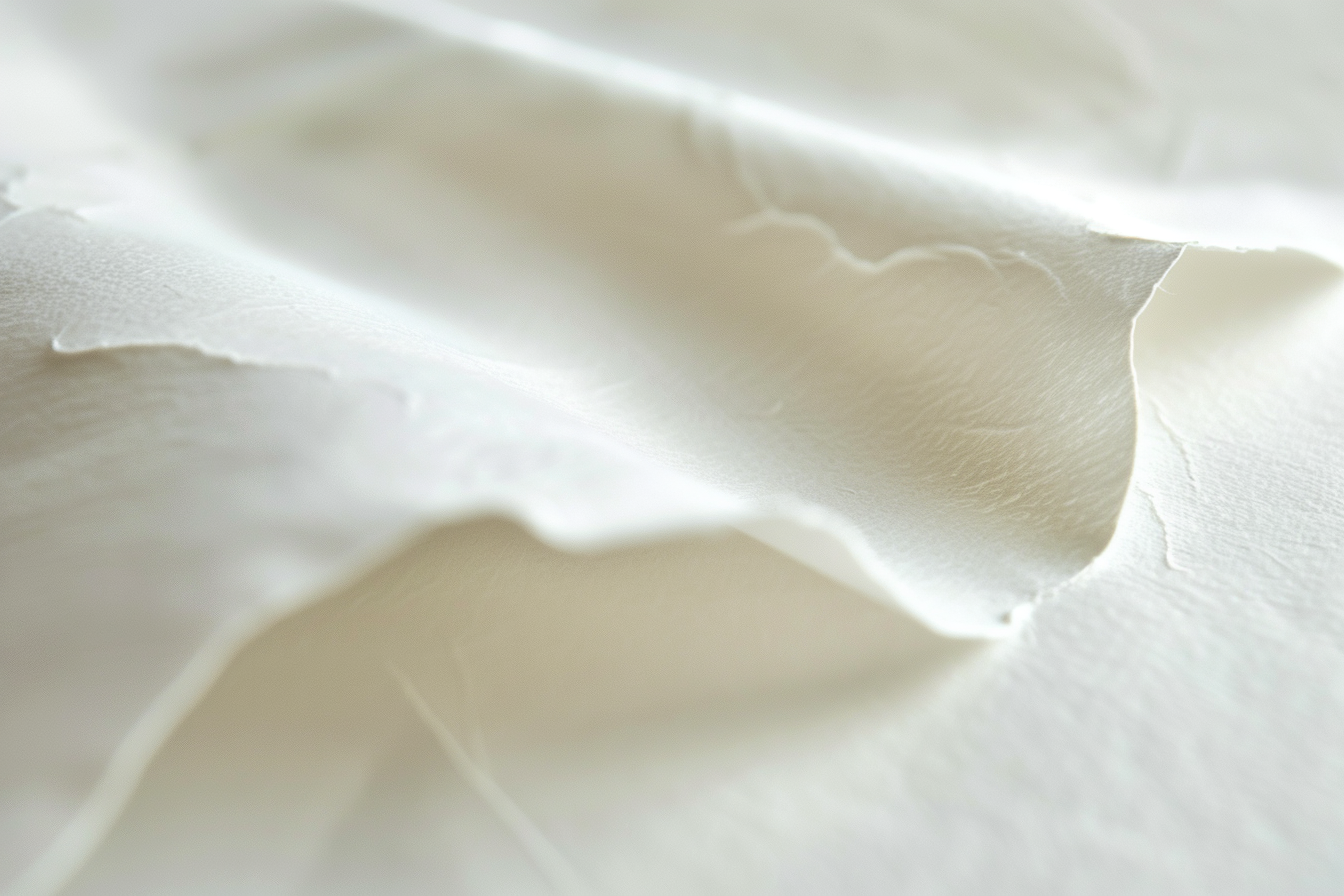 Close-up photograph of shiny white paper with textures