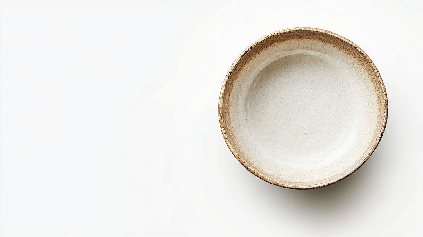 Empty deep bowl with earthy tones against white background.