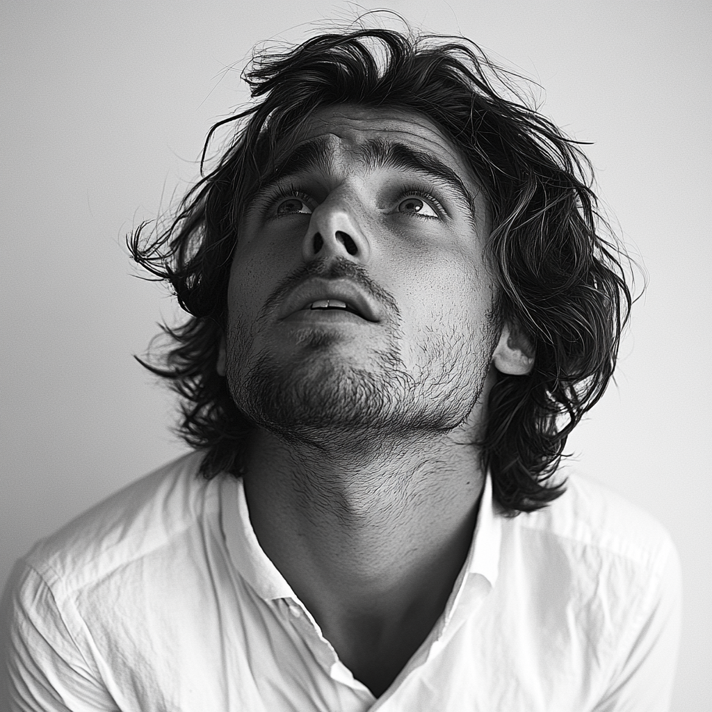 Frightened man with messy hair in white shirt portrait